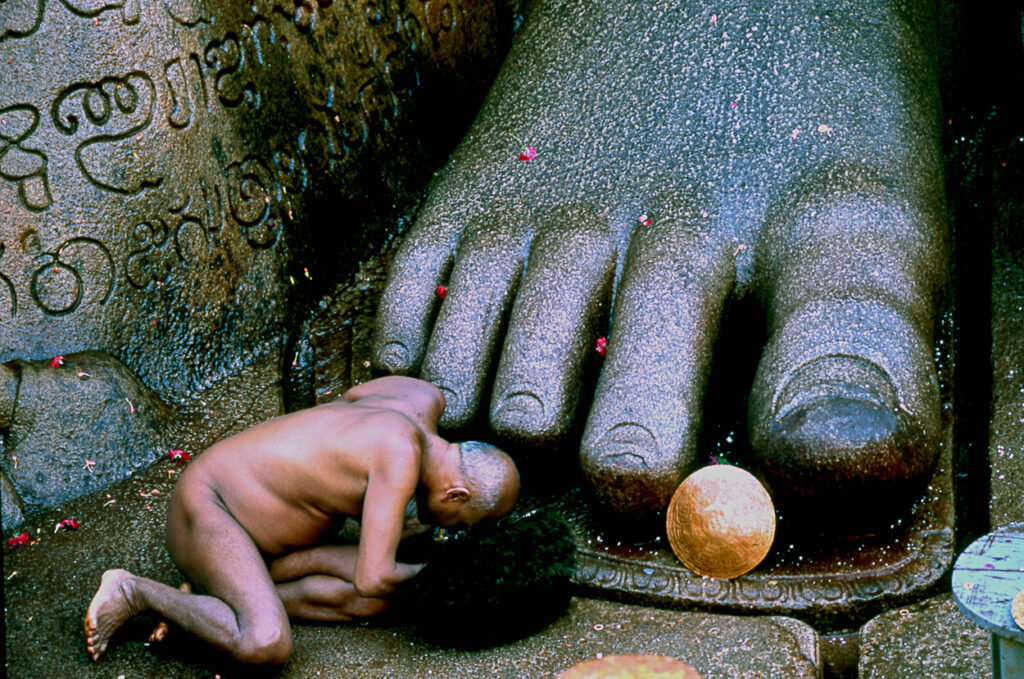 Jain monk at feet of Bahubali, Mahamastakabhisheka, Karnataka, India